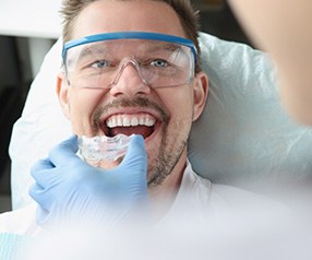 A dentist giving a nightguard to a patient