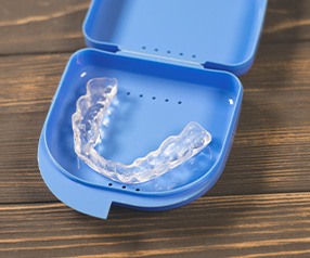 A nightguard placed inside a protective case