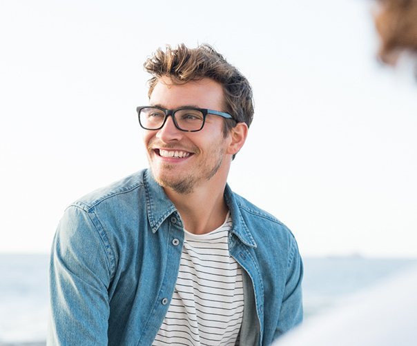 Closeup of man smiling outside with friends