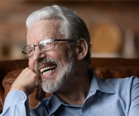 Man laughing on couch