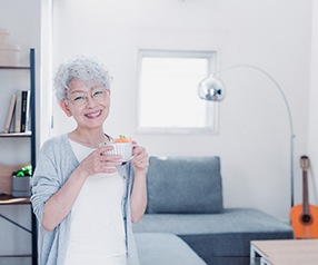 Woman preparing to eat with her dentures