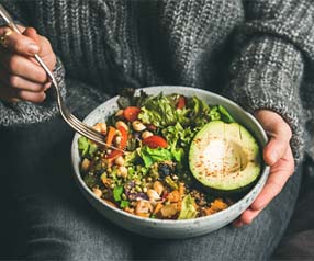 Man with dental implants in Tyler, TX eating a healthy salad