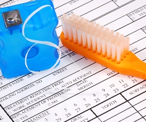 Dental insurance form, toothbrush, and floss