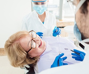 Woman smiling at her implant dentist in Tyler