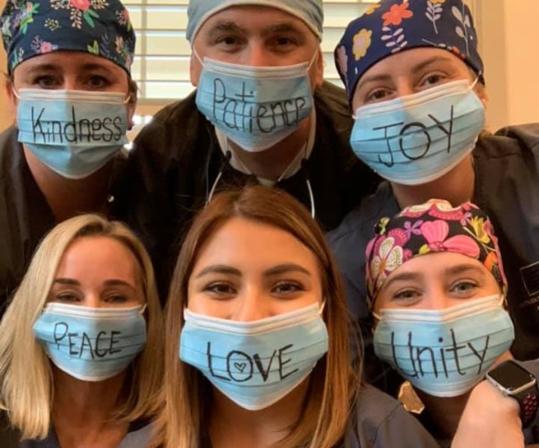 Tyler dental team members wearing face masks with words like kindness peace and love written on them
