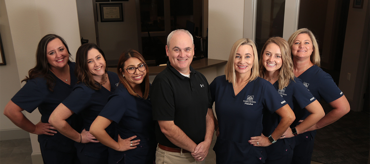 Smiling dentist and dental team members in Tyler