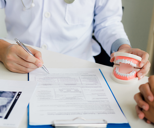 Person filling out dental insurance forms