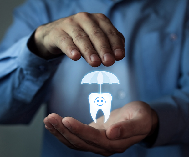 Hands holding animated tooth under an umbrella