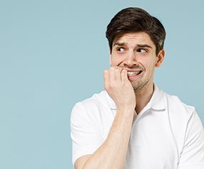 Man biting fingernails