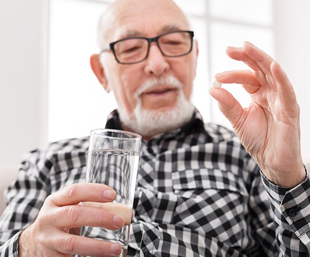 Man holding oral conscious dental sedation pill