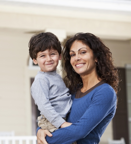 Mother holding son after children's dentistry visit