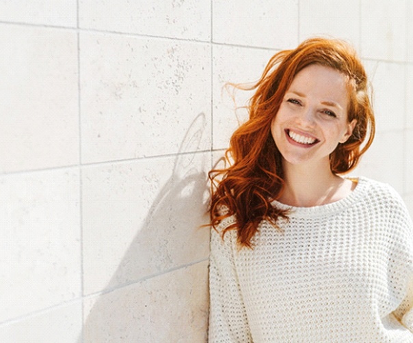 Woman with red hair smiling after smile makeover in Tyler