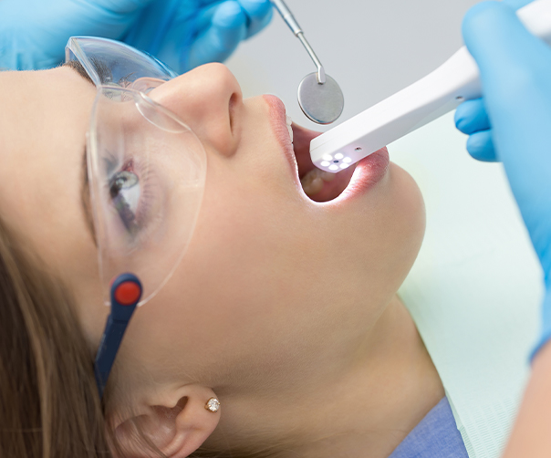 Dentist using intraoral camera to capture images