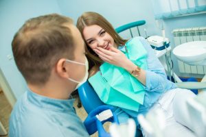 cosmetic dentist in Tyler explaining the difference between Invisalign and veneers 