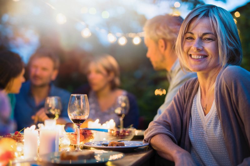 Woman having summer foods with dental implants