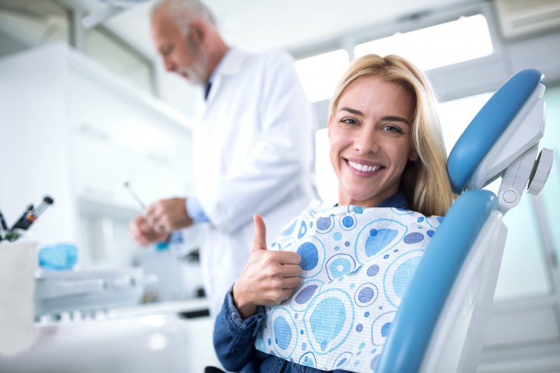 Dental patient giving a thumbs up